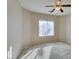 A cozy bedroom featuring natural light coming through the window and a ceiling fan for added comfort at 7649 Broadwing Dr, North Las Vegas, NV 89084