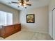Bedroom features natural light, ceiling fan, carpet flooring, storage chest and wall art at 7649 Broadwing Dr, North Las Vegas, NV 89084