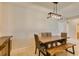 Dining area with a wood table and bench seating, complemented by tile flooring at 7649 Broadwing Dr, North Las Vegas, NV 89084