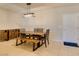 Tile dining area with modern light fixture, unique furniture, and access to front door at 7649 Broadwing Dr, North Las Vegas, NV 89084