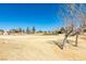 Scenic view of the golf course with clear blue skies and mountain views from the backyard at 7649 Broadwing Dr, North Las Vegas, NV 89084