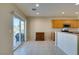 Kitchen dining nook area with wood cabinet and sliding door access to outdoor grill at 7649 Broadwing Dr, North Las Vegas, NV 89084