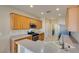 The kitchen is well-equipped with stainless steel appliances, light wood cabinets, and tile flooring at 7649 Broadwing Dr, North Las Vegas, NV 89084