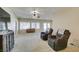 Spacious living area featuring plush seating, a ceiling fan, and natural light from large windows at 7649 Broadwing Dr, North Las Vegas, NV 89084