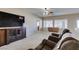 Inviting living space with recliners, entertainment center, and ample natural light through large windows at 7649 Broadwing Dr, North Las Vegas, NV 89084