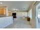 Open concept living room showing kitchen, ceiling fan, and living area with sliding glass doors to the backyard at 7649 Broadwing Dr, North Las Vegas, NV 89084