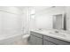 Bright bathroom with double vanity, a shower-tub combination, and a large mirror at 77 Tardando Ave, Henderson, NV 89015