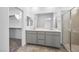 Modern bathroom featuring double sinks, walk-in shower and a walk-in closet at 77 Tardando Ave, Henderson, NV 89015