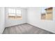 Bright bedroom with neutral carpet and two windows offering exterior views at 77 Tardando Ave, Henderson, NV 89015