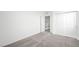 Bedroom with neutral carpet, a view of the staircase, and closet featuring sliding doors at 77 Tardando Ave, Henderson, NV 89015