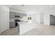 A well-lit kitchen with stainless steel appliances and an island with a sink at 77 Tardando Ave, Henderson, NV 89015