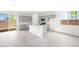 Bright kitchen with island, stainless steel appliances, and sliding glass door to the patio at 77 Tardando Ave, Henderson, NV 89015