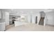 Open-concept floorplan with a well-equipped kitchen, island, and staircase at 77 Tardando Ave, Henderson, NV 89015