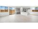 Bright, open kitchen with stainless steel appliances, white counters, and light gray cabinets at 77 Tardando Ave, Henderson, NV 89015