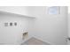 Bright laundry room with a utility sink and a shelf for storage at 77 Tardando Ave, Henderson, NV 89015
