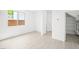 A clean and bright living area with light tile flooring and a large window at 77 Tardando Ave, Henderson, NV 89015