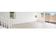 Bright living room featuring stairs, and access to the patio at 77 Tardando Ave, Henderson, NV 89015