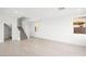 Bright and spacious living room featuring wood-look floors and staircase to the upper level at 77 Tardando Ave, Henderson, NV 89015