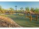 Community playground with unique wood frame climbing structures on a cushioned, artificial-turf surface at 77 Tardando Ave, Henderson, NV 89015