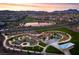 Expansive aerial view of the community featuring lush parks, a scenic lake, and winding pathways at 77 Tardando St, Henderson, NV 89015