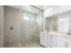 Modern bathroom featuring a glass-enclosed tiled shower, dual-sink vanity, and contemporary fixtures at 77 Tardando St, Henderson, NV 89015