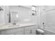 Bright, modern bathroom featuring a tiled shower with a glass door and a dual-sink vanity at 77 Tardando St, Henderson, NV 89015
