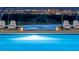 A refreshing community pool with lounge chairs and water features, perfect for relaxing and enjoying the outdoors at 77 Tardando St, Henderson, NV 89015