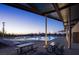 An inviting community pool with picnic tables and lounge chairs, set against a beautiful dusk sky at 77 Tardando St, Henderson, NV 89015