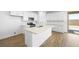 Bright kitchen with white cabinets, quartz countertops, stainless steel appliances, and a large island at 77 Tardando St, Henderson, NV 89015