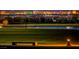 Nighttime park view featuring a lake, bench, and the Las Vegas skyline in the background at 77 Tardando St, Henderson, NV 89015