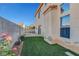 Private backyard with artificial turf, patio, and charming landscaping at 7721 Sour Gum Ct, Las Vegas, NV 89131