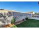 Beautiful backyard with artificial turf and vibrant rose bushes at 7721 Sour Gum Ct, Las Vegas, NV 89131