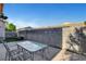 Lush backyard featuring an outdoor dining area and privacy fencing at 7721 Sour Gum Ct, Las Vegas, NV 89131