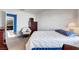 Neutral bedroom with TV on a tall dresser and seating for guests at 7721 Sour Gum Ct, Las Vegas, NV 89131