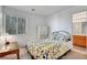 Bedroom featuring a queen-size bed, a desk, and a window with blinds at 7721 Sour Gum Ct, Las Vegas, NV 89131