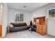 Bedroom featuring a futon, a desk, and a window with blinds at 7721 Sour Gum Ct, Las Vegas, NV 89131