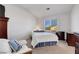 Bright bedroom with a large window, comfortable furnishings, and neutral decor at 7721 Sour Gum Ct, Las Vegas, NV 89131