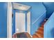 Bright entryway featuring wood floors, a white front door, and a staircase with wooden steps at 7721 Sour Gum Ct, Las Vegas, NV 89131
