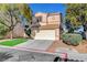 Attractive two-story house with neat landscaping, mature trees, and a two-car garage at 7721 Sour Gum Ct, Las Vegas, NV 89131