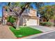 Inviting two-story home featuring a manicured lawn, mature trees, and a convenient two-car garage at 7721 Sour Gum Ct, Las Vegas, NV 89131