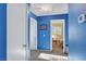 Hallway with blue walls leading to bedrooms; clean and well-lit space with white doors at 7721 Sour Gum Ct, Las Vegas, NV 89131