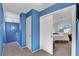 Upstairs hallway featuring blue walls, neutral carpet, and a doorway to a bedroom at 7721 Sour Gum Ct, Las Vegas, NV 89131