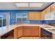 Well-lit kitchen with wood cabinets, laminate countertops and a breakfast nook with backyard views at 7721 Sour Gum Ct, Las Vegas, NV 89131