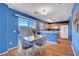 Bright kitchen featuring blue walls, breakfast nook, wood floors, and modern appliances at 7721 Sour Gum Ct, Las Vegas, NV 89131