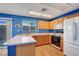 Eat-in kitchen featuring wood cabinets, white Corian countertops, and stainless-steel appliances at 7721 Sour Gum Ct, Las Vegas, NV 89131