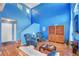 Open-concept living room with tall ceilings, hardwood floors, and an adjoining staircase at 7721 Sour Gum Ct, Las Vegas, NV 89131