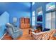 Inviting living room featuring soaring ceilings, hardwood floors, and comfortable seating at 7721 Sour Gum Ct, Las Vegas, NV 89131