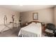 Neutral bedroom featuring a queen bed, side tables, and a comfortable workspace at 7769 Peaceful Trellis Dr, Las Vegas, NV 89179