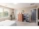 Spacious bedroom featuring a large window with natural light and a tall dresser at 7769 Peaceful Trellis Dr, Las Vegas, NV 89179