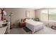 Comfortable bedroom with a large window and a view of the outdoors at 7769 Peaceful Trellis Dr, Las Vegas, NV 89179